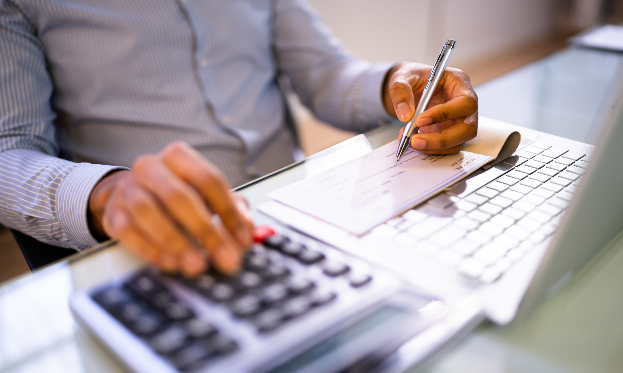 A man calculating compensation amounts in an Owasso car crash claim